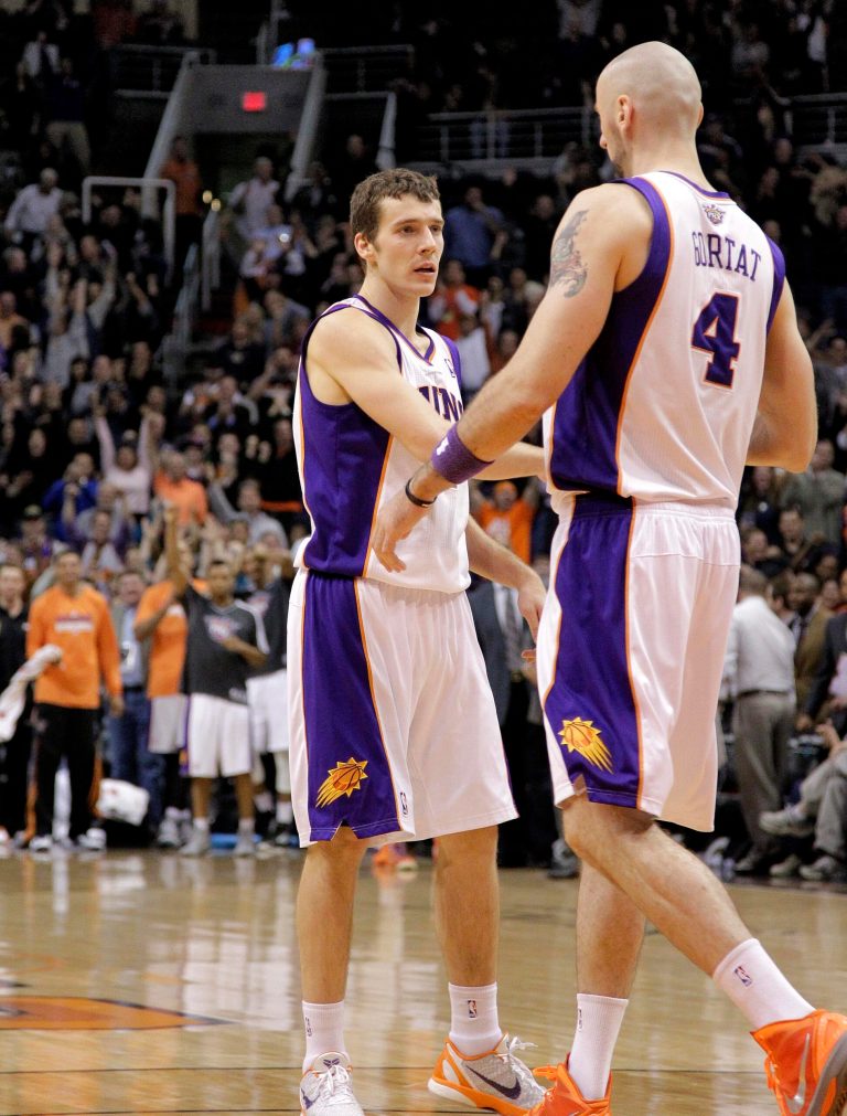   Phoenix Suns' Marcin Gortat (4), of Poland, greets teammate Goran Dragic, of Slovenia, after Dragic made the game-winning shot against the Memphis Grizzlies during the second half of an NBA basketball game on Wednesday, Dec. 12, 2012, in Phoenix. The Suns won 82-80. (AP Photo/Matt York)  