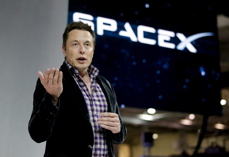 FILE - In this Thursday, May 29, 2014, file photo, Elon Musk, CEO and CTO of SpaceX, introduces the SpaceX Dragon V2 spaceship at the SpaceX headquarters on, in Hawthorne, Calif.  Tesla Motors is opening access to its patents to accelerate electric vehicle development. Musk says the company will share several hundred patents and won't sue those who use them. (AP Photo/Jae C. Hong, File)