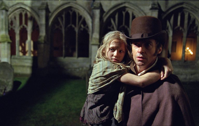   This film image released by Universal Pictures shows Hugh Jackman as Jean Valjean holding Isabelle Allen as Young Cosette in a scene from 