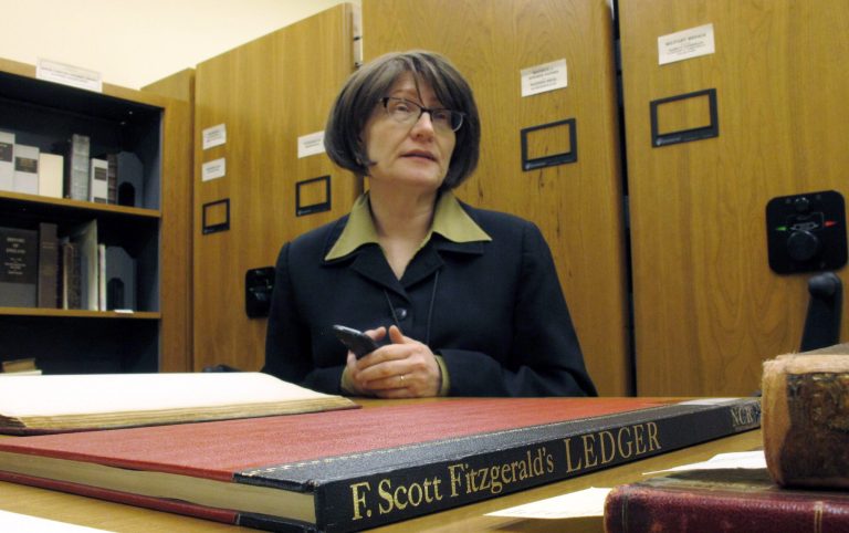 In this Tuesday, March 26, 2013 photo, Elizabeth Sudduth, director of the Ernest F. Hollings Library and Rare Books Collection at the University of South Carolina, talks about a ledger owned by author F. Scott Fitzgerald, in Columbia, S.C. The university has digitized the ledger and put it online for scholars. (AP Photo/Jeffrey Collins)