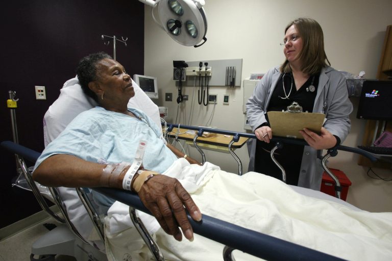 In this May 27, 2010 photo, Dr. Rebecca Parker talks to 74-year-old patient Charlene Ladner in the emergency room of Chicago's Advocate Trinity Hospital. (AP Photo/Kiichiro Sato)