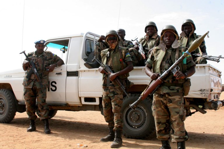 United Nations peacekeeping troops protect a U.N. police patrol a refugee camp in North Darfur on Sudan, January 2008. (AP Photo/Alfred de Montesquiou)