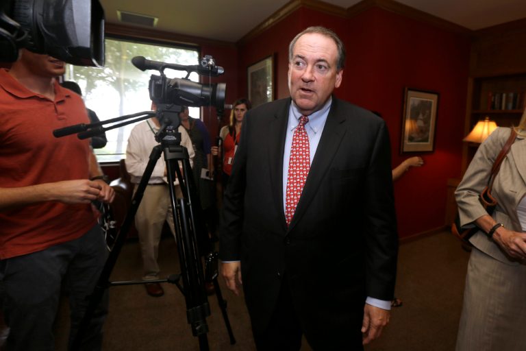 Former Republican Arkansas Gov. Mike Huckabee walks past video cameras after a news conference in Little Rock, Ark., Monday, Aug. 25, 2014. (AP Photo/Danny Johnston)