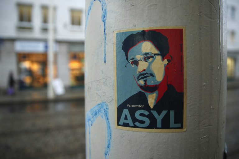 A sticker demanding asylum for whistleblower and former NSA worker Edward Snowden hangs stuck to a lamppost on January 5, 2015 in Dresden, Germany. (Photo by Sean Gallup/Getty Images)