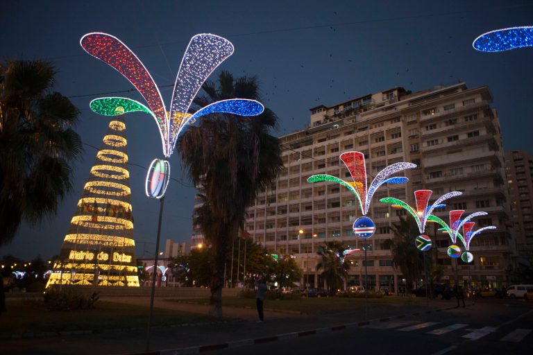   In this Tuesday, Dec. 11, 2012 photo, people walk past Christmas decorations in Independence Square in central Dakar, Senegal. As Christmas approaches in mostly Muslim Senegal, vendors ply the streets selling tinsel, artificial trees, and inflatable Santas, and the main boulevards are all aglow in holiday lights. Senegal, a moderate country along Africa's western coast, has long been a place where Christians and Muslims coexist peacefully and share in each other's holidays. (AP Photo/Rebecca Blackwell)  
