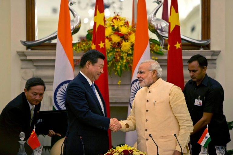 Chinese President Xi Jinping shakes hands with Indian Prime Minister Narendra Modi, right after signing agreements in New Delhi, India, Thursday, Sept. 18, 2014. Xi vowed to bring prosperity to Asia and create opportunities for the world as he and Modi began talks Thursday to deepen cooperation through investment and trade. (AP Photo /Manish Swarup)