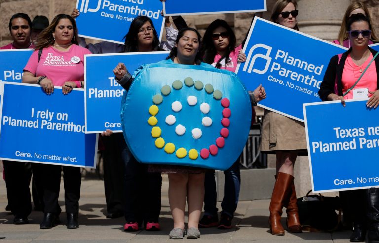 Alyssa Travino, center, of Edinburg, Texas, wears a birth control bill box costume during a Planned Parenthood rally on the steps of the Texas Capitol on March 7, 2013, in Austin, Texas. A federal appeals court was set to review a Texas law that led to the closing of many abortion clinics in the state, a case that ultimately appears to be bound for the U.S. Supreme Court. (AP Photo/Eric Gay)
