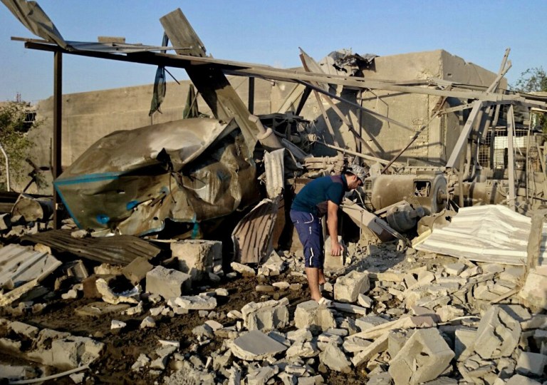 A generator owner inspects his community generator that was destroyed after a bombing in Fallujah, 40 miles west of Baghdad, Iraq in this Tuesday, July 29, 2014 file photo. (AP Photo, File)