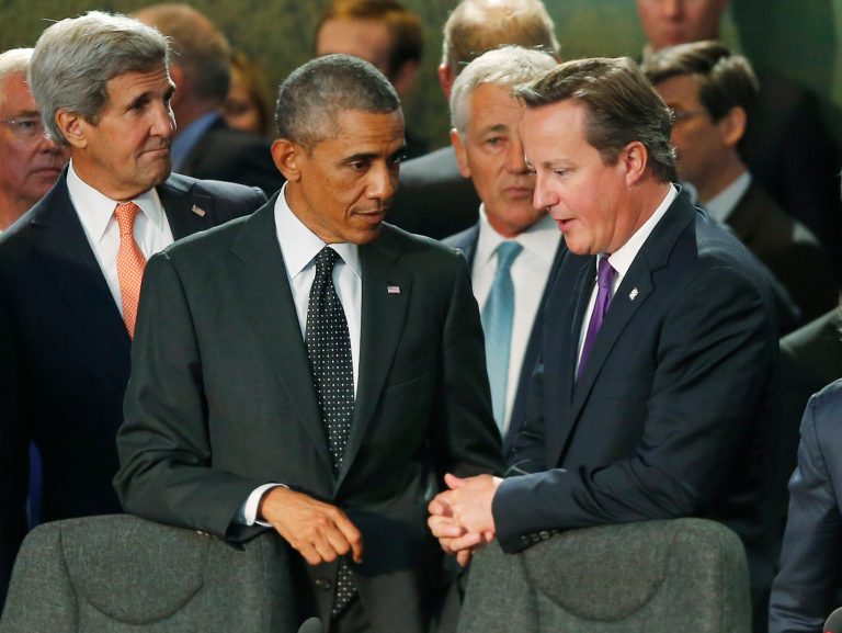 President Obama talks with British Prime Minister David Cameron as Secretary of State John Kerry and Defense Secretary Chuck Hagel stand at rear before NATO leaders meet regarding Afghanistan at the NATO summit at Celtic Manor in Newport, Wales, Thursday, Sept. 4, 2014. (AP Photo/Charles Dharapak)