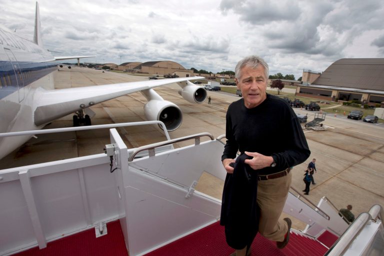 FILE - In this Sept. 28, 2013, file photo U.S. Secretary of Defense Chuck Hagel boards his plane at Andrews Air Force Base, Md., en route to South Korea. Saturday, Oct. 5, 2013, the Pentagon ordered most of its approximately 400,000 furloughed civilian employees back to work. The decision by Hagel is based on a Pentagon legal interpretation of a law called the Pay Our Military Act. That measure was passed by Congress and signed by President Barack Obama shortly before the partial government shutdown began Tuesday, Oct. 1. The Pentagon did not immediately say on Saturday exactly how many workers will return to work, but use the term 