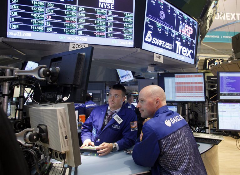 FILE- In this Friday, June 29, 2012, file photo Specialists Frank Masello, left, and John T. O'Hara work on the trading floor of the New York Stock Exchange in New York shortly before the closing bell. World stock markets rose Wednesday April 16, 2014 as China's slowdown in the first quarter was less severe than expected.    (AP Photo/David Karp, File)