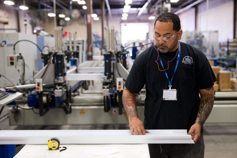 In this Aug. 7, 2014 photo a worker assembles construction supplies at Northeast Building Products in Philadelphia. The Commerce Department issues its second estimate of how fast the U.S. economy grew in the April-June quarter on Thursday, Aug. 28, 2014. (AP Photo/Matt Rourke)