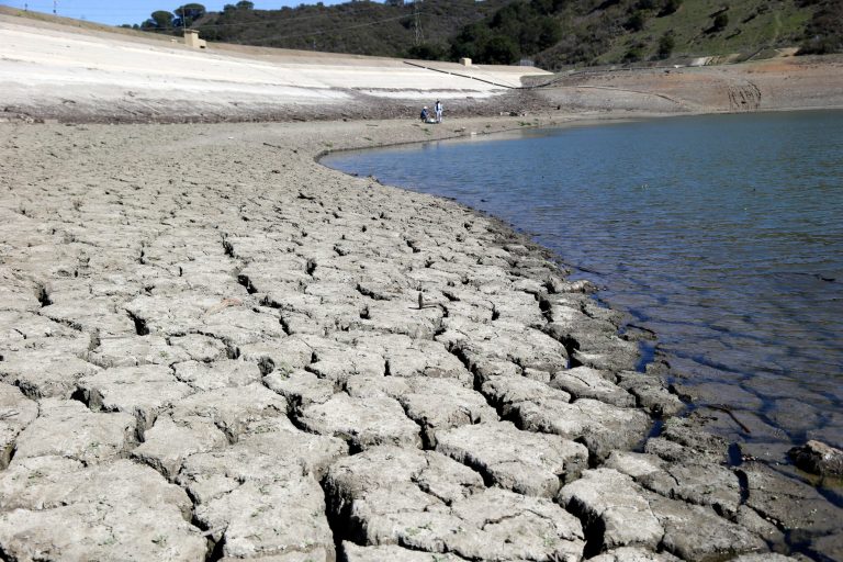 Cracked ground is shown amid California's drought.