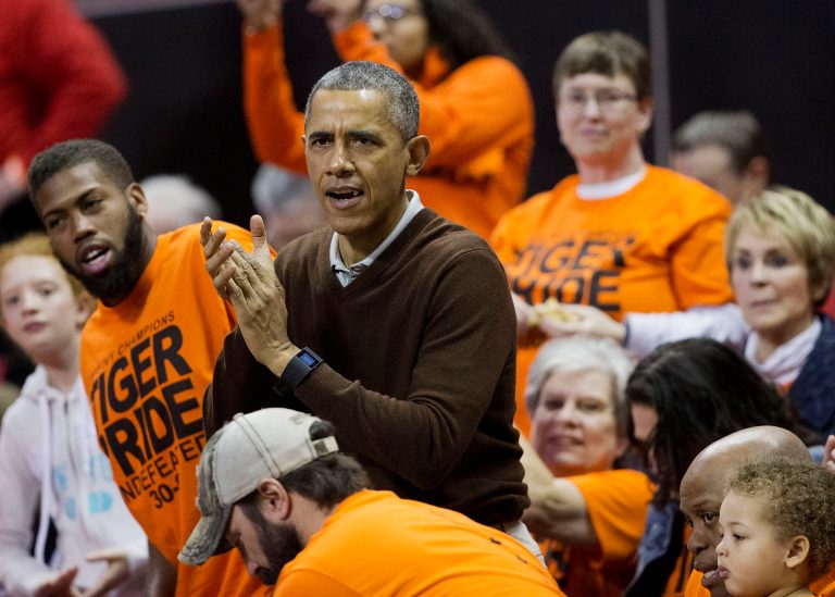 President Obama cheers at the Princeton game against Wisconsin-Green Bay women's college basketball game in the first round of the NCAA tournament in College Park, Md., Saturday, March 21, 2015. Obama's niece Leslie Robinson, plays for Princeton. (AP Photo/Pablo Martinez Monsivais)