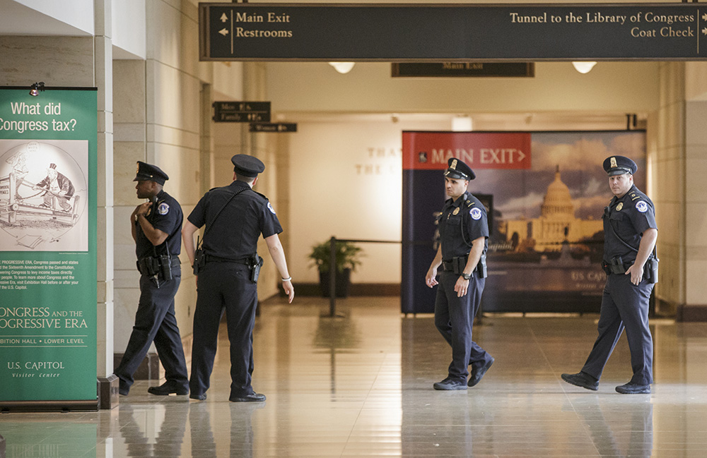 Capitol gun suspect charged, still hospitalized