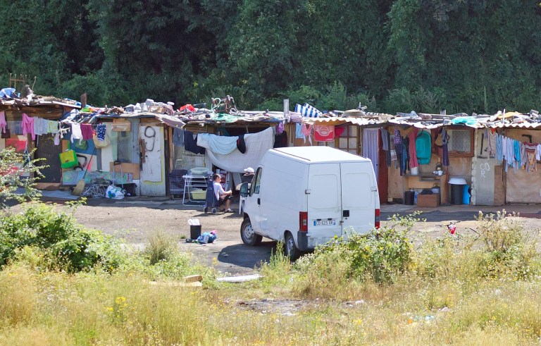 FILE - This Friday Aug. 10, 2012, file photo shows a Roma encampment set up near a highway in Clamart, west of Paris. A vigilante attack against a Roma teenager is causing alarm at France's highest levels, after a group of people who suspected the boy of burglary seized him from his camp last Friday, beat him into unconsciousness and left him for dead. (AP Photo/Michel Euler, File)