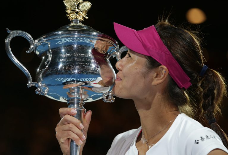 Li Na of China kisses the championship trophy after defeating Dominika Cibulkova of Slovakia in their women's singles final at the Australian Open tennis championship in Melbourne, Australia, Saturday, Jan. 25, 2014.(AP Photo/Aaron Favila)