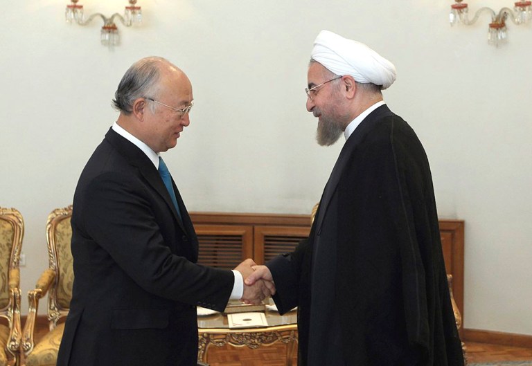 In this photo released by the official website of the office of the Iranian Presidency, Iran's President Hassan Rouhani, right, shakes hands with Director General of the International Atomic Energy Agency Yukiya Amano at the start of their meeting in Tehran, Iran, Sunday, Aug. 17, 2014. (AP Photo/Mohammad Berno, Iranian Presidency Office)
