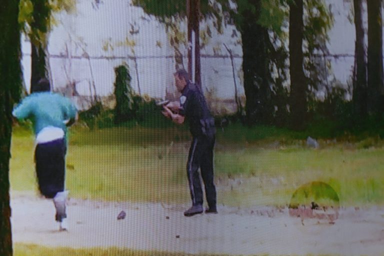 A video showing former North Charleston police officer, Michael Slager holding Walter Scott, is shown in court during his Slager's murder trial at the Charleston County court in Charleston, S.C., Tuesday, Nov. 15, 2016. (Grace Beahm/Post and Courier via AP, Pool)