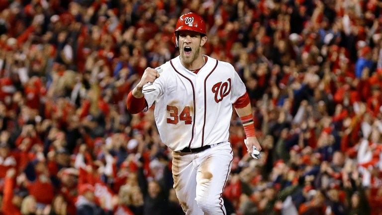 FILE - This Oct. 12, 2012 file photo shows Washington Nationals' Bryce Harper reacting as he heads home on a home run by Ryan Zimmerman during the first inning of Game 5 of the National League division baseball series against the St. Louis Cardinals in Washington. Harper is favored to win the NL Rookie of the Year, Monday, Nov. 12, 2012.(AP Photo/Alex Brandon, File)