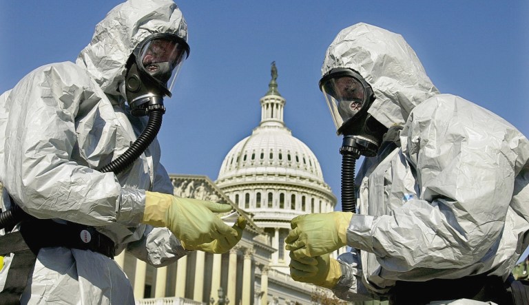 In this Oct. 30, 2001, file photo, members of the U.S. Marine Corps' Chemical-Biological Incident Response Force demonstrate anthrax clean-up techniques during a news conference in on Capitol Hill in Washington. (AP Photo/Kenneth Lambert, File)