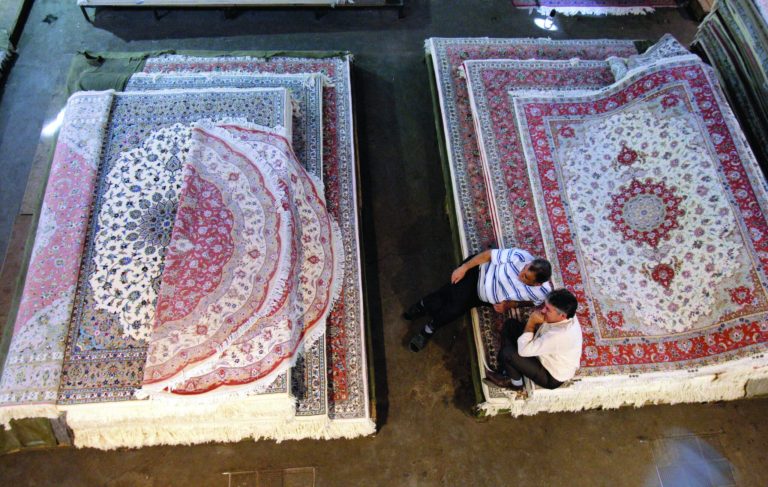 Iranian carpet sellers wait for customers at Tehran's old main bazaar in downtown Tehran, Iran, Sunday, Oct. 7, 2012. Iran's parliament on Sunday abandoned its planned impeachment of a Cabinet minister over the free-fall of the country's currency, opting instead to look for more effective economic measures, like cutting spending. The aborted move to impeach the minister reflects unease over the severe drop in the value of the Iranian rial, mostly because of Western sanctions over Iran's suspect nuclear program. On Sunday the parliament approved outlines of a bill to restrict the government's use of different exchange rates for its foreign revenue and requiring the return of some funds to the treasury. (AP Photo/Vahid Salemi)