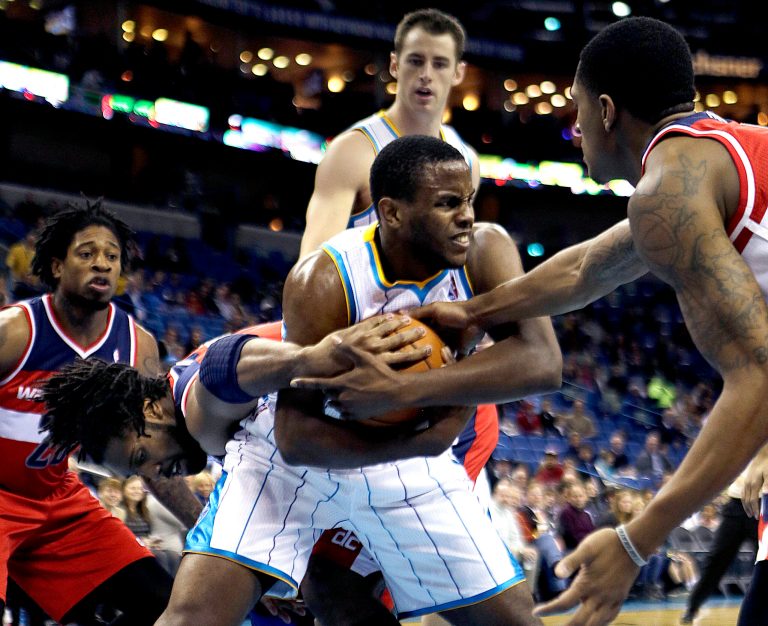   New Orleans Hornets forward Darius Miller, center, battles for a rebound with Washington Wizards center Nene, left, and guard Bradley Beal, right, in the first half of an NBA basketball game in New Orleans, Tuesday, Dec. 11, 2012. (AP Photo/Gerald Herbert)  