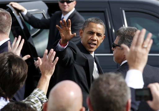 President Barack Obama waves to a crowd on the tarmac as he leaves the Dayton International Airport for a campaign event in the Dayton, Ohio, Tuesday, Oct. 23, 2012. (AP Photo/David Kohl)