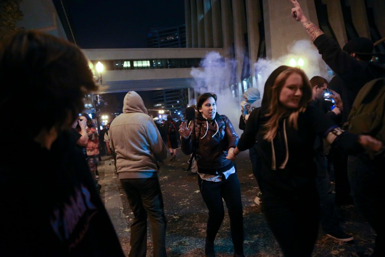 Police in downtown Portland, Ore., attempt to disperse people protesting the election of President-elect, Donald Trump, Friday, Nov. 11, 2016. (Stephanie Yao Long/The Oregonian via AP)