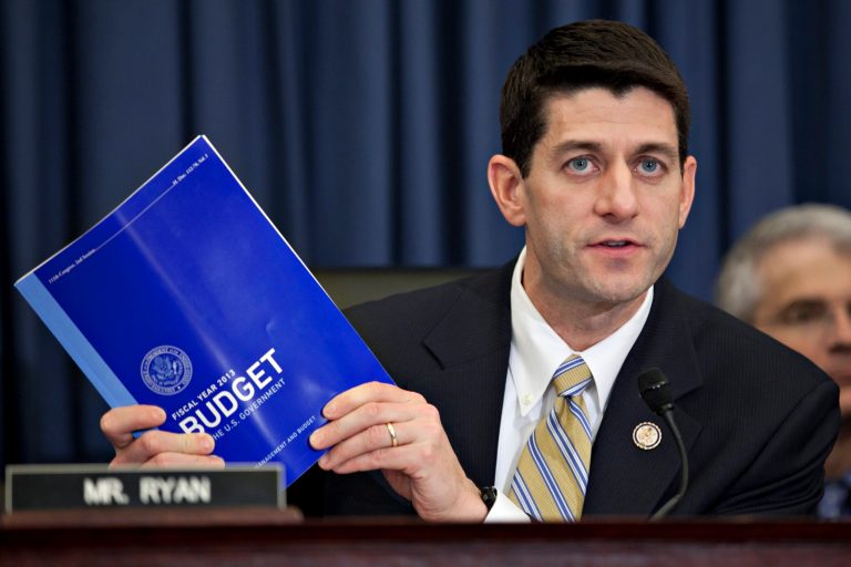 Representative Paul Ryan, a Republican from Wisconsin, holds a copy of the Fiscal Year 2013 Budget while chairing a House Budget Committee hearing ( Andrew Harrer/Bloomberg)