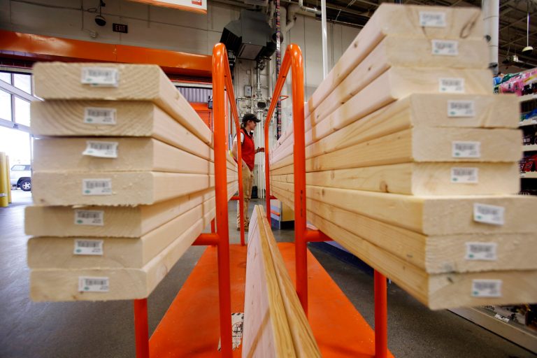 In this May 17, 2014 photo, a shopper checks out with her lumber at a Home Depot in Boston. Home Depot reports quarterly financial results Tuesday, Aug. 19, 2014. (AP Photo/Gene J. Puskar)