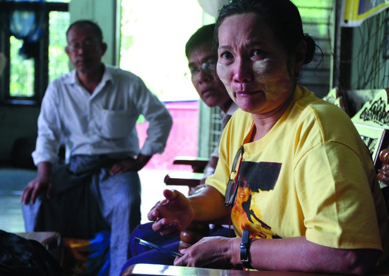 In this photo taken on Sept. 15, 2012, Htet Htet Oo Wai, right, a land rights activist and a member of Myanmar opposition leader Aung San Suu Kyi's National League for Democracy party, talks during an interview in Yangon, Myanmar. The landscape of Mingaladon township, northern outskirts of Yangon, tells a story of economic upheaval. Skeletons of factories for a new industrial zone rise from thick green rice paddies local farmers say were seized illegally by the Zaykabar Company, one of Myanmar's most powerful companies. Human rights groups say land battles could intensify because companies tied to the military and business elite are rushing to grab land as the country emerges from five decades of isolation and opens its economy. (AP Photo/Khin Maung Win)