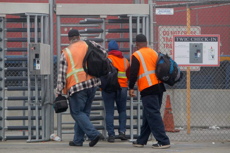   Port workers return to work at the Port of Long Beach Wednesday, Dec. 5, 2012. Work resumed at the Los Angeles and Long Beach harbors after settlement of a strike that crippled the nation's busiest container port complex for more than a week. (AP Photo/Nick Ut)  