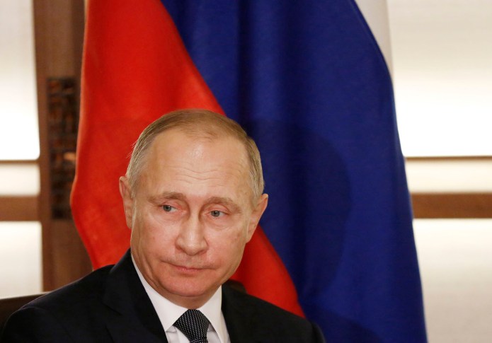 "His having been the head of the KGB, does that surprise you?" Reid said of Putin. "And did it surprise anyone today when he denied it?" (Toru Hanai/Pool Photo via AP)