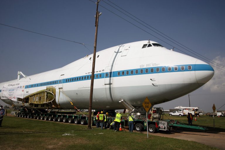The Boeing 747 Shuttle Carrier Aircraft makes its way under power lines at Ellington Field, Monday, April 28, 2014, in Conroe, Texas. The power poles had to be extended for the plane to fit under. It will travel at least two nights to the Space Center Houston. (AP Photo/Conroe Courier, Kar R Hlava)