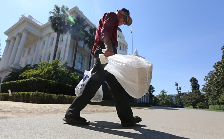 In this photo taken Tuesday, Aug. 12, 2014, plastic single-use bags are carried past the State Capitol in Sacramento, Calif.  The state Assembly rejected legislation that would make California the first in the U.S. to impose a statewide ban on single-use plastic bags. SB270, by state Sen. Alex Padilla,  failed Monday on a 37-33 vote after an hour-long debate. It can be heard again this week. (AP Photo/Rich Pedroncelli)