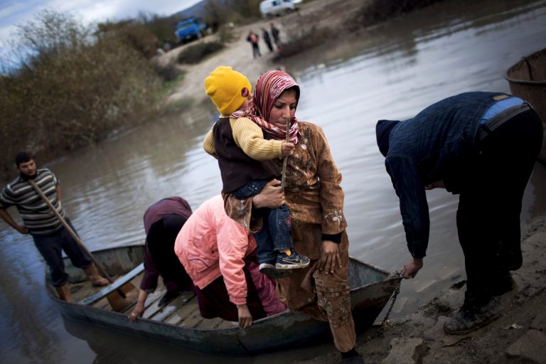 FILE - In this Dec. 8, 2012, file photo, Syrian refugees cross from Syria to Turkey by the Orontes river, near the village of Hacipasa, Turkey. Across the region women lead about a quarter of all Syrian refugee families, which number some 145,000, the United Nations estimated in a report issued Tuesday, July 8, 2014. (AP Photo/Manu Brabo, File)