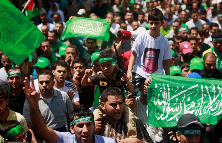 Palestinian supporters of Hamas and the Islamic Jihad movement chant slogans against the Israeli military action in Gaza, during a demonstration in the West Bank city of Jenin on Friday. (AP/Mohammed Ballas)