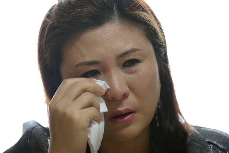 HOLD FOR USE WITH STORY SLUGGED
KOREAS-EMBATTLED EX-SPY BY HYUNG-JIN KIM, IN THIS PICTURE TAKEN ON FRIDAY, APRIL 11, 2014, Won Jeong-hwa wipes a tear from her face during an interview with The Associated Press at her apartment in Gunpo, south of Seoul, South Korea. (AP Photo/Lee Jin-man)