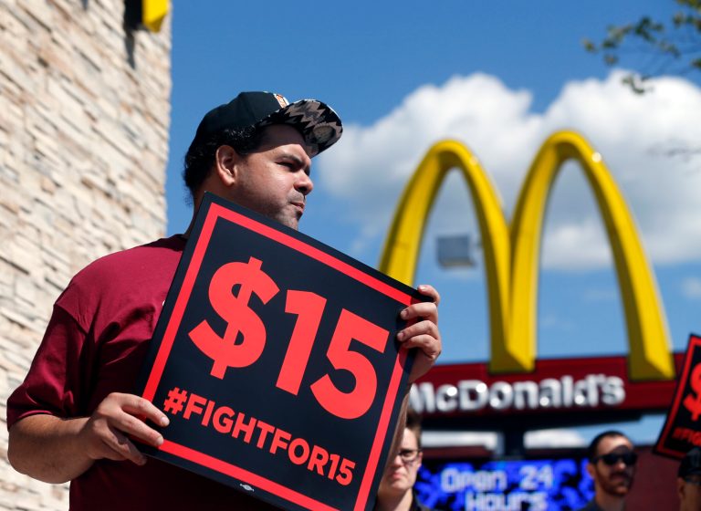 Supporters of a $15 minimum wage for fast food workers rally in front of a McDonald's on Wednesday, July 22, 2015, in Albany, N.Y. (AP Photo/Mike Groll)