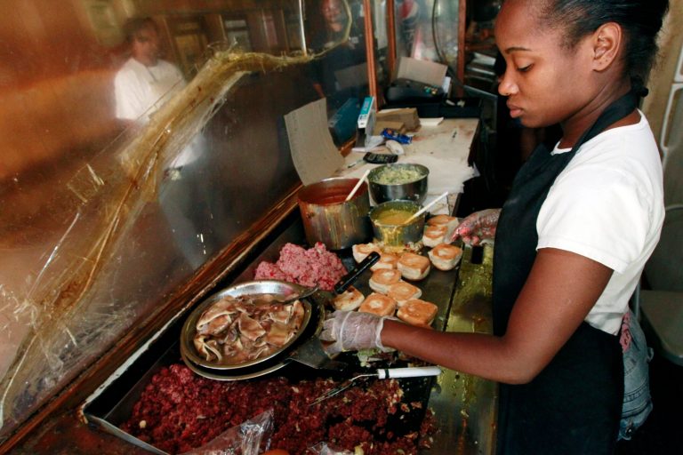   In this May 29, 2012 photograph, Big Apple Inn grill cook Tyechia Davis prepares the sausage meat for a 