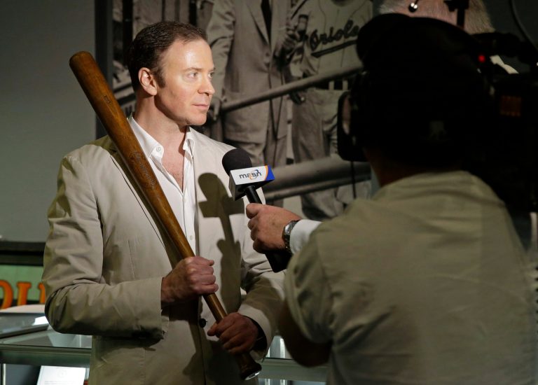Goldin Auctions president Ken Goldin holds a baseball bat that Babe Ruth used early in his career, Wednesday, July 9, 2014, in Baltimore, as he is interviewed during a media preview of sports memorabilia slated for auction to mark the 100th anniversary of Ruth's major league debut. The auction is scheduled to take place July 12, the day after the anniversary, and the organizers estimate that 125 items to be auctioned off could fetch as much as $10 million. (AP Photo/Patrick Semansky)