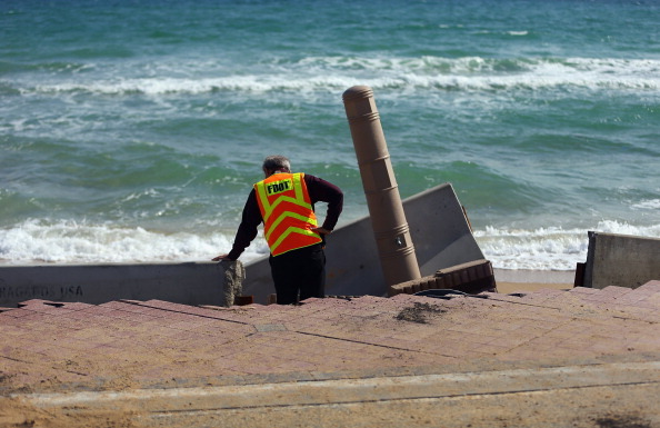 FORT LAUDERDALE, FL - NOVEMBER 27:  Florida Department of Transportation Operations Engineer, Cleo Marsh, inspects the damage done to route A-1-A by the ocean, making parts of it impassable to vehicles on November 27, 2012 in Fort Lauderdale, Florida. The beach was eroded away last month when Hurricane Sandy passed by to the east and now City officials are saying that the damage may preview what rising sea levels can mean for coastal communities throughout South Florida. Climate scientists predict sea levels in South Florida will rise by 1 foot by 2070, 2 feet by 2115, and 3 feet by 2150.  (Photo by Joe Raedle/Getty Images)