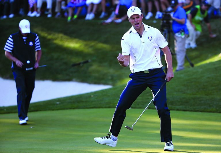Ross Kinnaird/Getty Images
Martin Kaymer's par putt on the 17th green secured a 141Ã2131Ã2 victory for Europe at the Ryder Cup.
