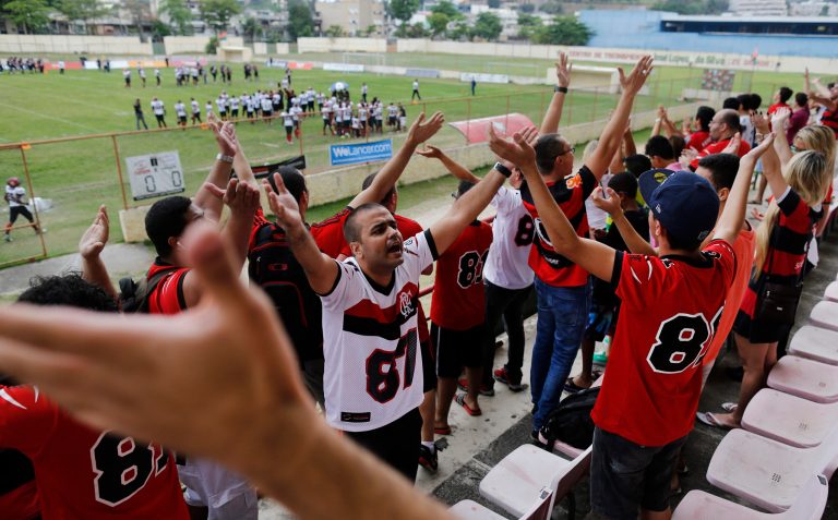 Fans of Flamengo Futebol Americano team wave their hands during aTouchdown tournament match at Portuguesa stadium in Rio de Janeiro, Brazil, Saturday, Sept. 27, 2014. American football, once the sport Brazilians couldn't understand, is quickly gaining space in the land of soccer, attracting a growing number of fans and participants. (AP Photo/Leo Correa)