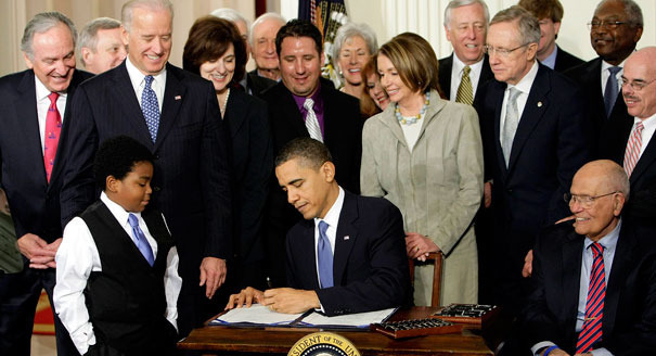 When President Obama signed his health care act, the administration went to work drawn up hundreds of new regulations. AP Photo