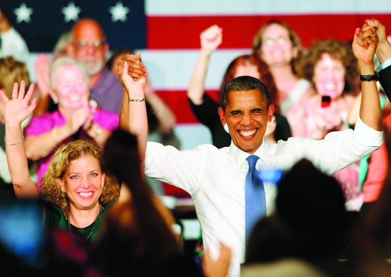 President Obama raises arms with Rep. Debbie Wasserman Schultz (D-FL) after delivering remarks to seniors at Century Village on July 19, 2012 in West Palm Beach, Florida. (Photo by Marc Serota/Getty Images)