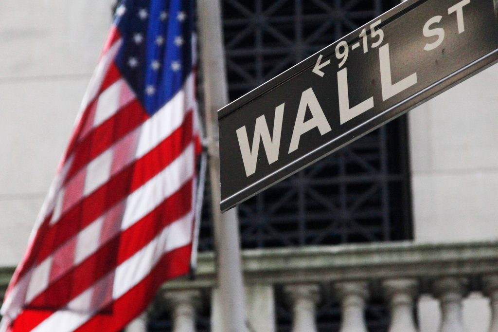 Stocks notch tiny gains, but still end week lower