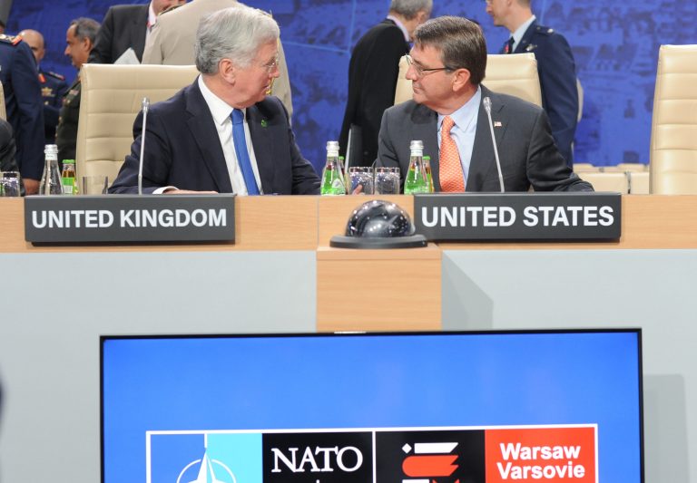 Ash Carter, right, and his British counterpart Michael Fallon talk prior to the defense ministers session during the second day of the NATO Summit, in Warsaw, Poland, on July 9, 2016. (AP Photo/Alik Keplicz)