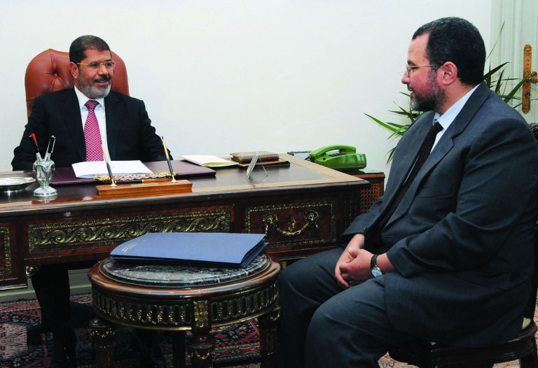 FILE - In this Sunday, July 22, 2012 file photo released by the Egyptian Presidency, Egyptian President, Mohammed Morsi, left, meets with the minister of Water Resources and Irrigation, Hesham Kandil, at the Presidential Palace in Cairo. Egypt's Islamist president is to swear in a new Cabinet as tensions rise over the country's tenuous security, recent sectarian violence and popular discontent over issues such as widespread water and power outages. The U.S.-educated Kandil will announce the Cabinet lineup on Thursday before he and his ministers are sworn in by Morsi. (AP Photo/Ahmed Mourad, Egyptian Presidency, File)